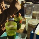 An individual making fresh juice at a market stall in Bình Thuận, Vietnam.